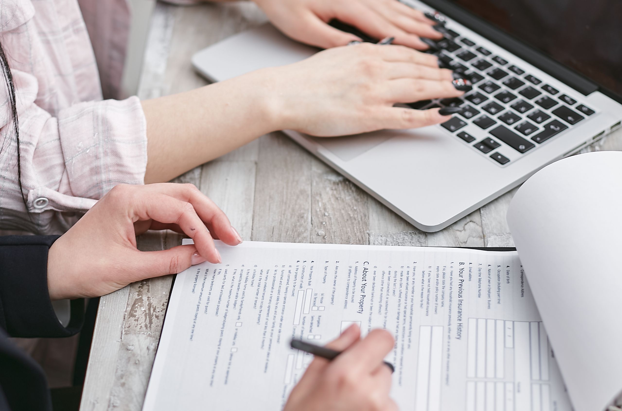 Self-employed worker completing autónomo registration paperwork at a laptop in Spain
