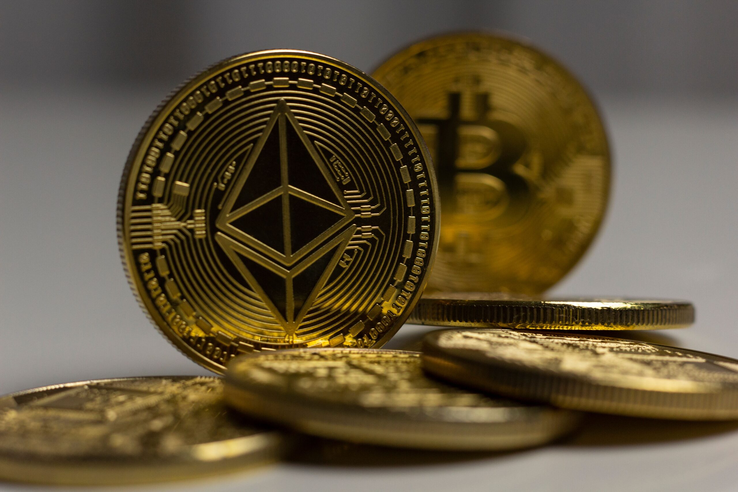 Bitcoin and Ethereum coins beside a trading chart, representing cryptocurrency taxation in Spain