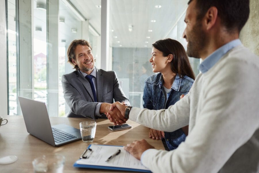 Insurance broker in Spain explaining a visa-compliant health policy to a client