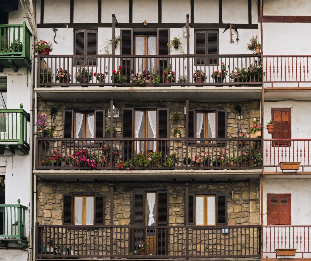 Facade of a Spanish residential apartment building with balconies and shutters, the type of property most foreign buyers purchase through the resale process