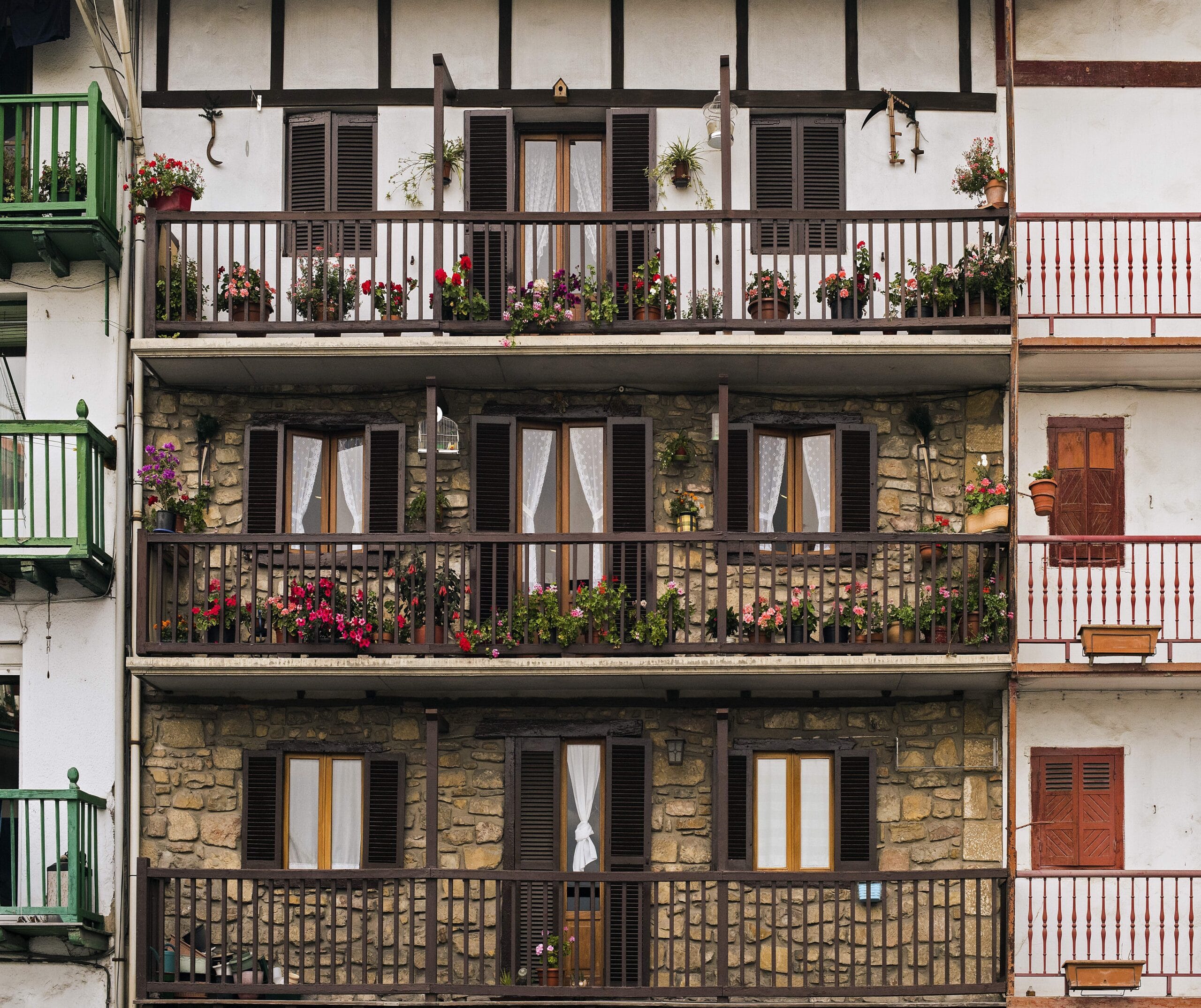 Facade of a Spanish residential apartment building with balconies and shutters, the type of property most foreign buyers purchase through the resale process