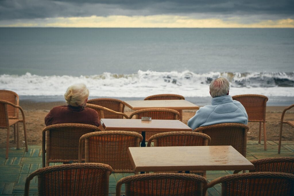 Retired couple on a Mediterranean terrace in Spain, the typical profile of a Non-Lucrative Visa applicant living on passive income